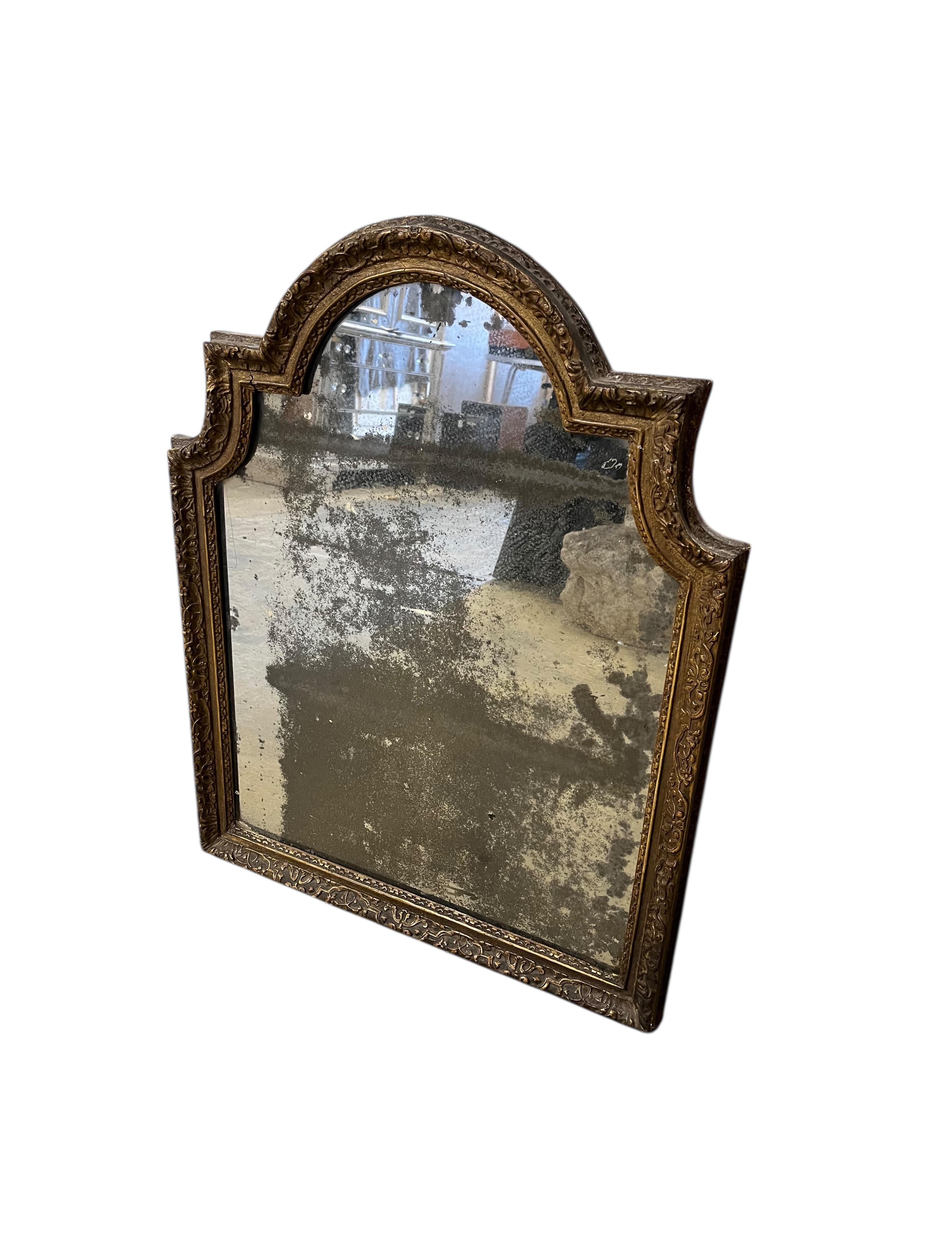 An 18th century carved giltwood wall mirror, width 60cm, height 76cm